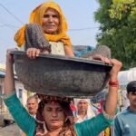 bahu-carrying-90-year-old-mother-in-law-on-head-c